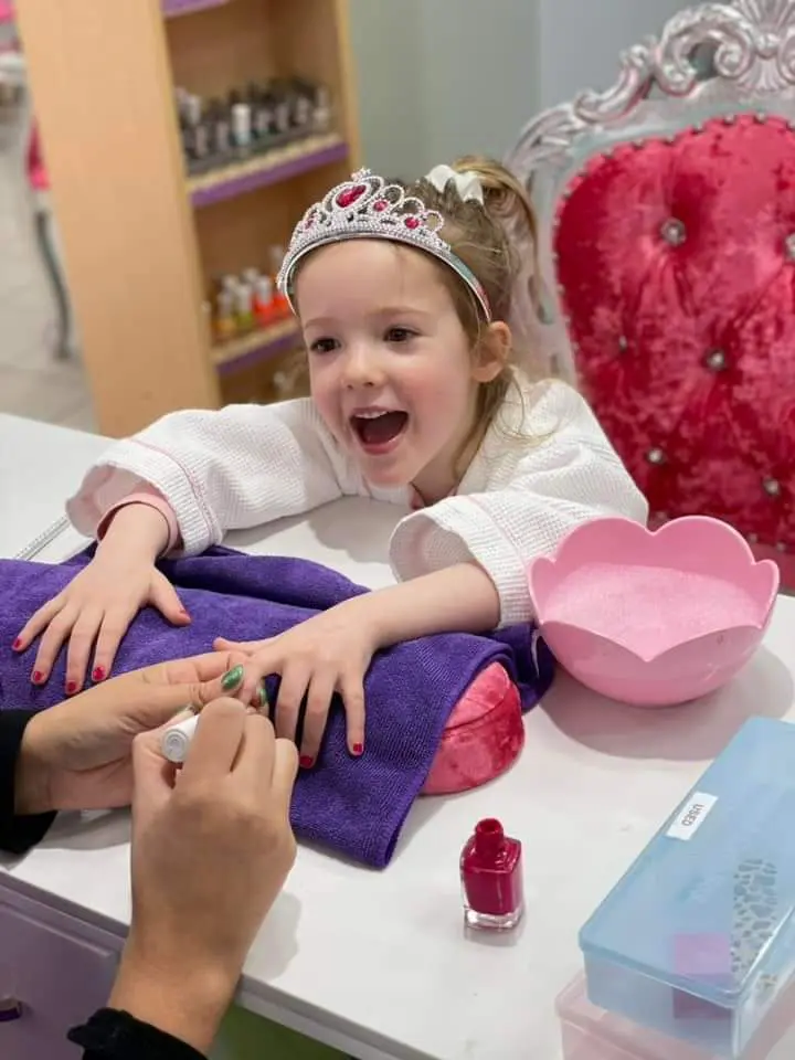 A little girl getting her nails done at the nail salon